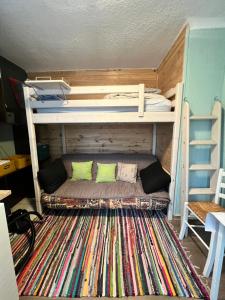a room with two bunk beds and a rug at Studio centre-ville in Cluses