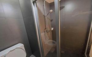 a shower stall with a toilet in a bathroom at Next Bird Suite in Bangkok +81 photos