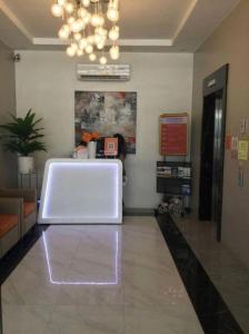 a lobby with a large white object on the floor at Capital O 804 The Residences at Bonifacio Civic Center in Manila +146 photos