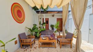 a patio with two chairs and a table at Casa María Eulalio - Boutique Guesthouse in Mérida