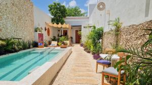 a house with a swimming pool in a yard at Casa María Eulalio - Boutique Guesthouse in Mérida
