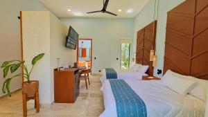 a hotel room with two beds and a desk at Casa María Eulalio - Boutique Guesthouse in Mérida +78 photos