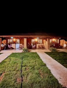a brick house with a lawn in front of it at Hospedaria MM in Carolina