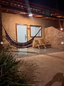 a room with a hammock in a brick building at Hospedaria MM in Carolina