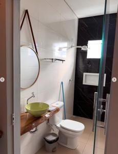 a bathroom with a sink and a toilet and a mirror at Hospedaria MM in Carolina