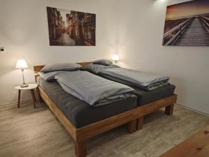 two twin beds in a room with a painting on the wall at Apartment in Landsberg, Erpfting in Landsberg am Lech
