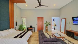a living room with a large bed and a couch at Casa María Eulalio - Boutique Guesthouse in Mérida