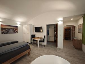 a room with a bed and a desk and a table at Apartment in Landsberg, Erpfting in Landsberg am Lech