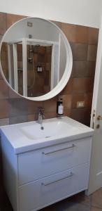 a bathroom with a white sink and a mirror at Dimora degli Gnomi in Tirano