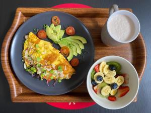 une assiette de nourriture avec une omelette et un bol de fruits dans l'établissement Cabañas Ecoturísticas Villa Beatrice, à Estación El Salto