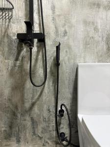 a shower in a bathroom with a black shower head at Reinforce Residence in Thulusdhoo