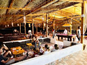 a group of people sitting on seats in a restaurant at Magic land taba camp in Taba