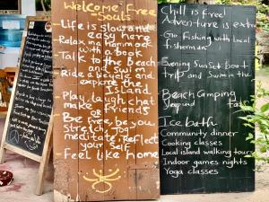 a chalkboard with writing on it next to a sign at Delft Village stay in Delft East