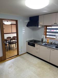 a kitchen with a sink and a table with a dining room at Huis Tashiro in Yuzawa +17 photos