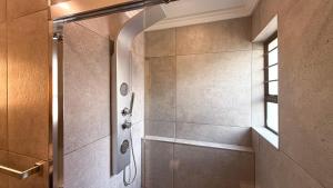 a shower stall in a bathroom with a window at Titanic View - Place of Peace in Clarens +119 photos