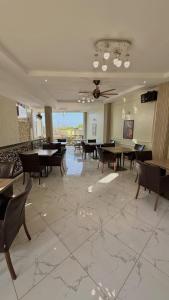 a dining room with tables and chairs and a ceiling fan at Villa Carino Kilifi Kenya in Kilifi +8 photos