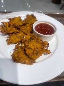 a plate of fried food with a dipping sauce at Dreamy Delight in Nathia Gali