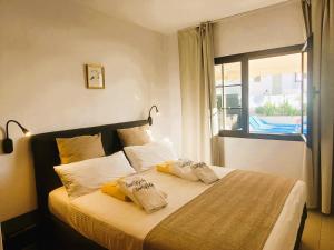 a bedroom with a bed with two pillows on it at Villa Vista with heated pool & Jacuzzi in Playa Blanca +37 photos