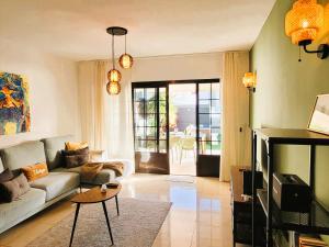 a living room with a couch and a table at Villa Vista with heated pool & Jacuzzi in Playa Blanca