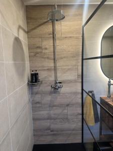 a shower with a glass door in a bathroom at JustB in Riemst