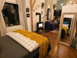 a living room with a bed and a mirror at Boutique Apartment Benz 2 in Bergisch Gladbach