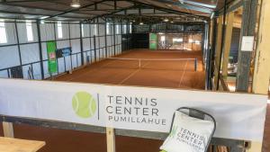a tennis court in a building with a sign on it at Cabaña Mirador de ballenas,Chiloé in Ancud