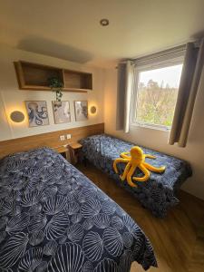 a bedroom with a bed with a yellow teddy bear on it at Het Strandnest in Renesse +34 photos