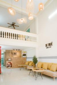 a living room with a couch and tables at De Rivé 2 Homestay Cần Thơ in Can Tho