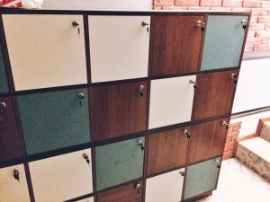 a large wooden chest of drawers with glass doors at Capsularhouse Hostel in Dnipro
