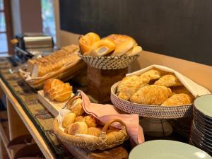 a buffet with baskets of bread and pastries on a counter at Hotel Tulor in San Pedro de Atacama +60 photos