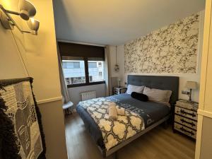 a small bedroom with a bed and a window at Puro Centro in Escaldes-Engordany