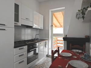 a kitchen with a table and a stove top oven at La Villetta in Vittorito