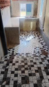 a bathroom with a sink and a tiled floor at Turtle beach Bar 1 Bedroom in Thai Muang
