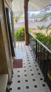 a porch of a house with a tree at Turtle beach Bar 1 Bedroom in Thai Muang +2 photos