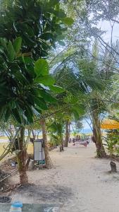 a beach with trees and people on the beach at Turtle beach Bar 1 Bedroom in Thai Muang