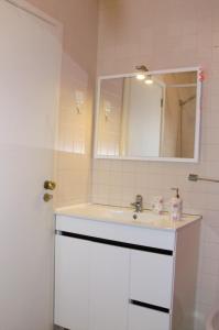 a bathroom with a white sink and a mirror at The Yellow House in Vila Nova de Gaia +25 photos
