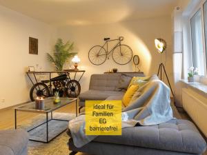 a living room with a couch and a bike on the wall at Ferienhaus Däschinger in Mastershausen