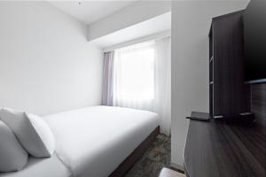 TV a/nebo společenská místnost v ubytování Sotetsu Fresa Inn Kitahama