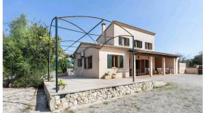 a house with a gate in front of it at Sa Torreta in Algaida