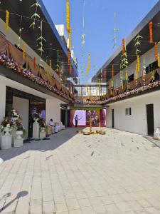 an empty courtyard of a building with a person standing in it at Hotel unity Park in Pondicherry