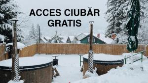 a garden covered in snow with the words acres guitar cribs at Vila Belcin Spa&Retreat in Buşteni