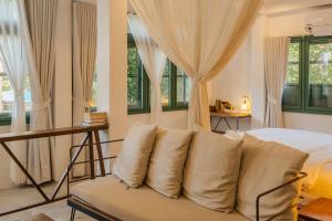 a bedroom with a couch in front of a bed at Big Tree Boutique Hotel in Ko Tao