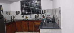 a kitchen with a counter top and a window at Grape Garden in Varkala