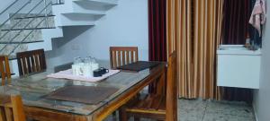a dining room table with a glass counter top at Grape Garden in Varkala +6 photos