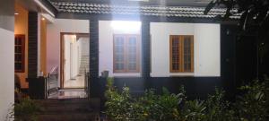 a house with two doors and some plants at Grape Garden in Varkala