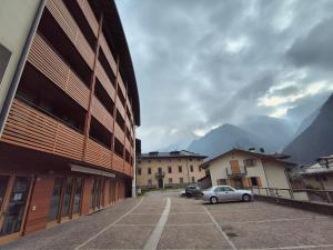 a car parked in a parking lot next to a building at WHITE ALPS Apartment in Schilpario