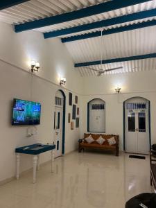 a living room with a couch and a flat screen tv at The Coastal Nest in Daman