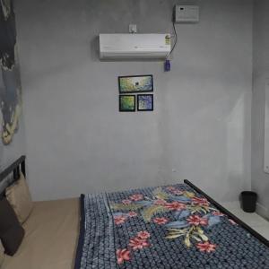 a room with a bed with a quilt on it at nyagaon swimming pool in Malaut +3 photos