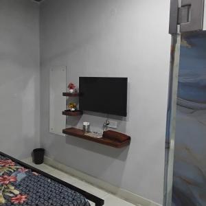 a flat screen tv on a wall in a room at nyagaon swimming pool in Malaut
