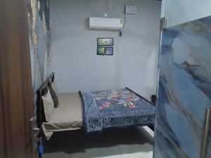 a small room with a small bed in it at nyagaon swimming pool in Malaut